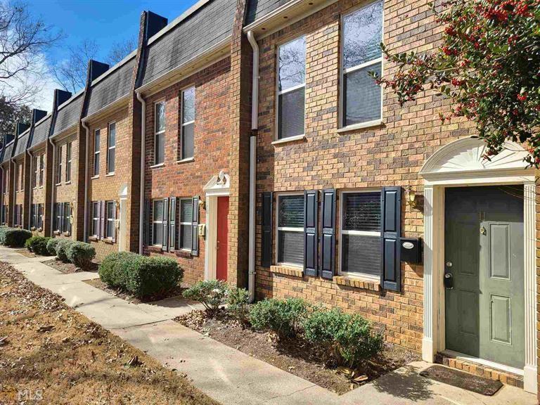175 North River Drive, Unit H Sandy Springs, GA 30350 - Photo 1 of 1 a view of a brick building with many windows