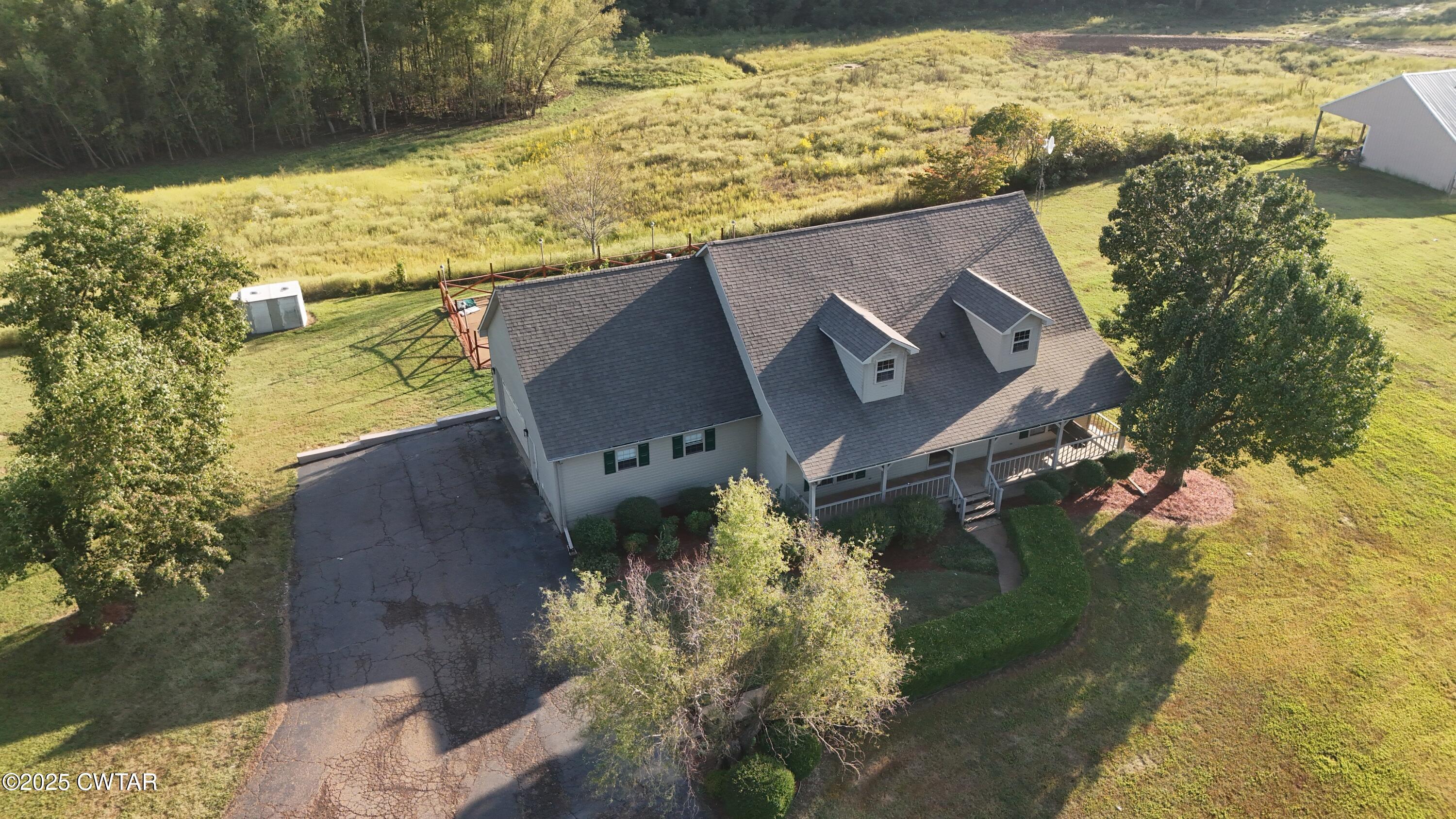 a aerial view of a house with a yard