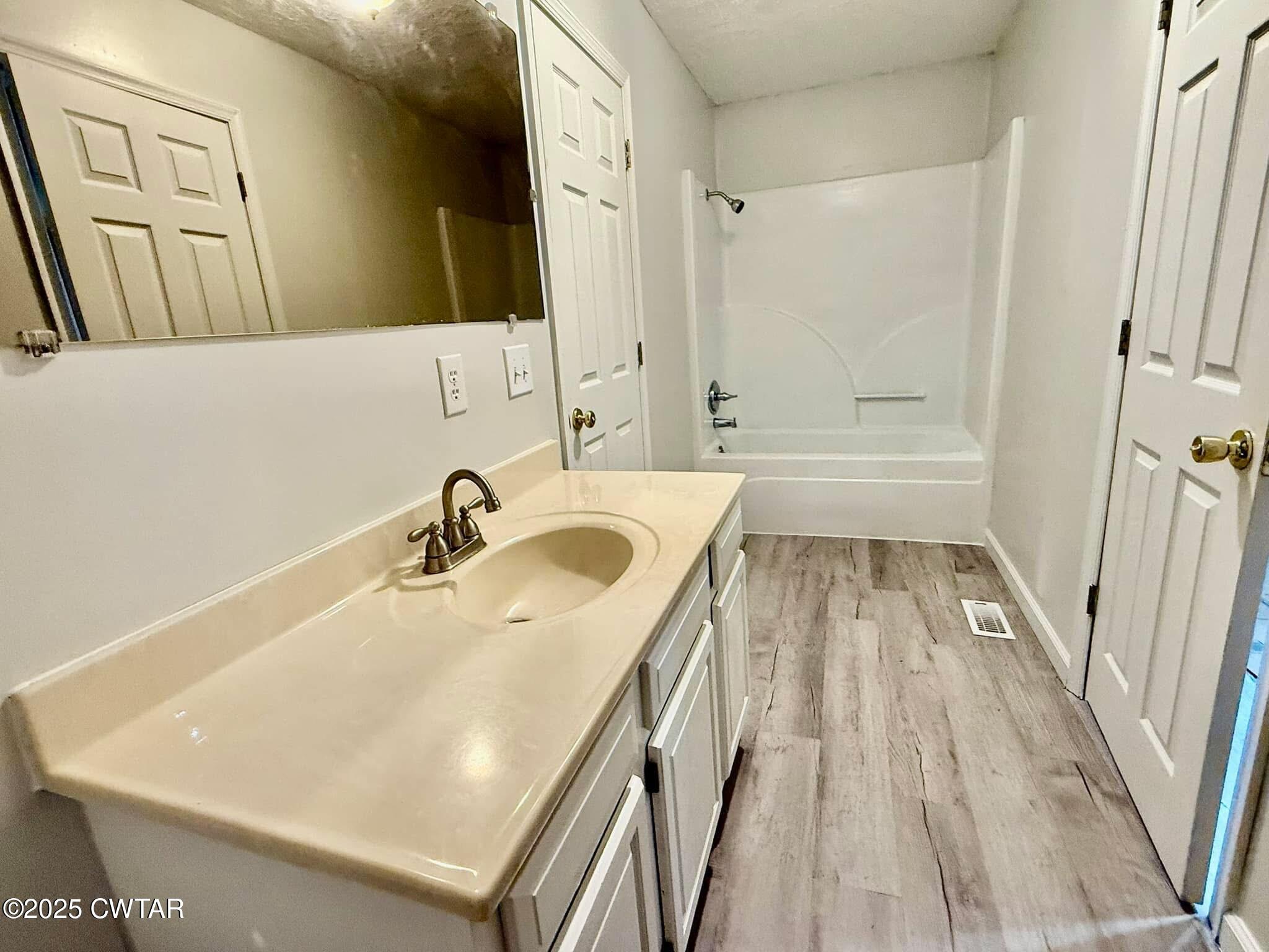 1559 Ella Groom Road Troy, TN 38260 - Photo 22 of 23 a bathroom with a sink a mirror and a bathtub