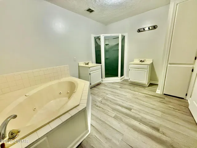 a bathroom with a bathtub and a sink