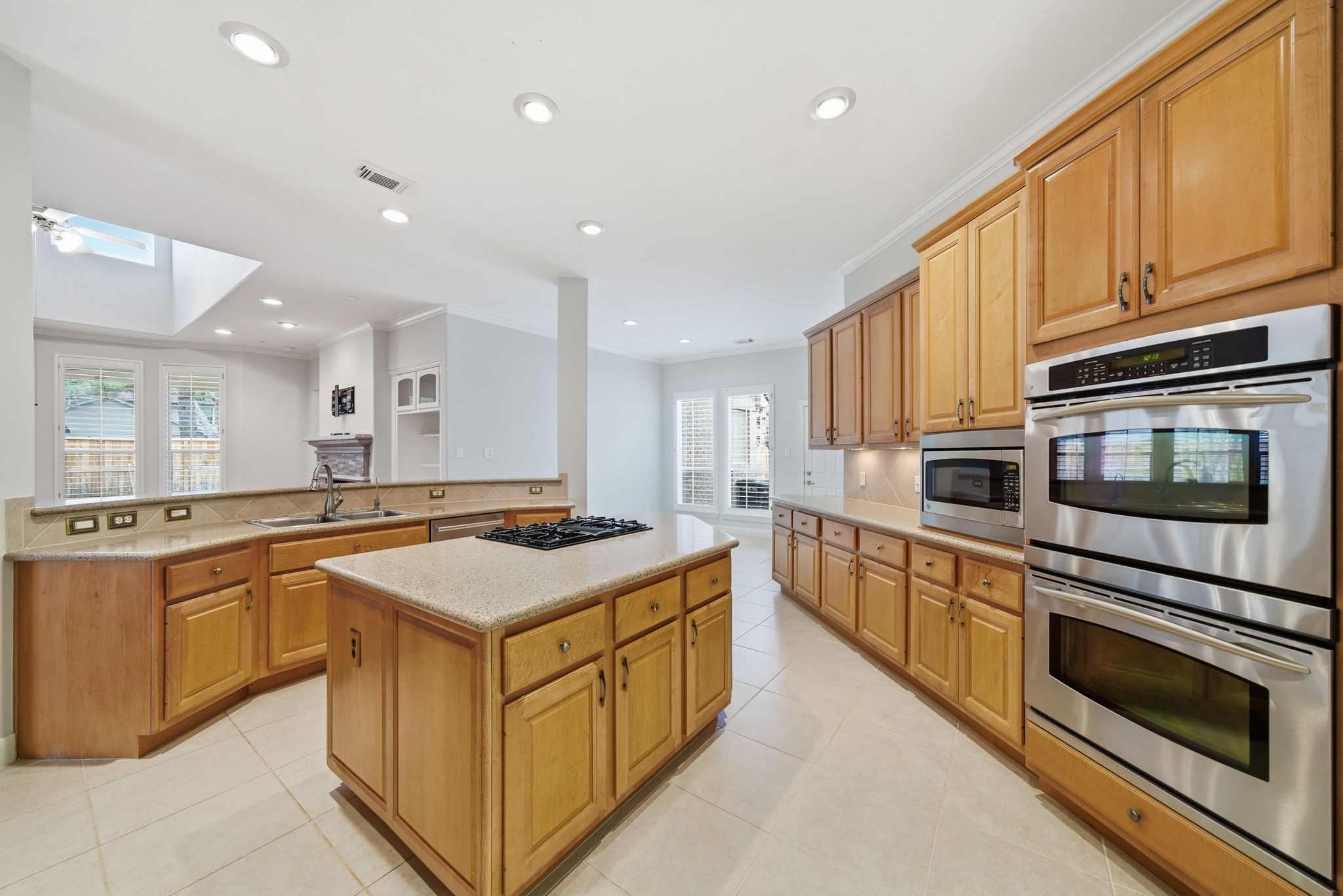 2842 Nicks Run Lane Katy, TX 77494 - Photo 11 of 35 a kitchen with stainless steel appliances granite countertop a stove top oven a sink dishwasher and a microwave oven with large trees