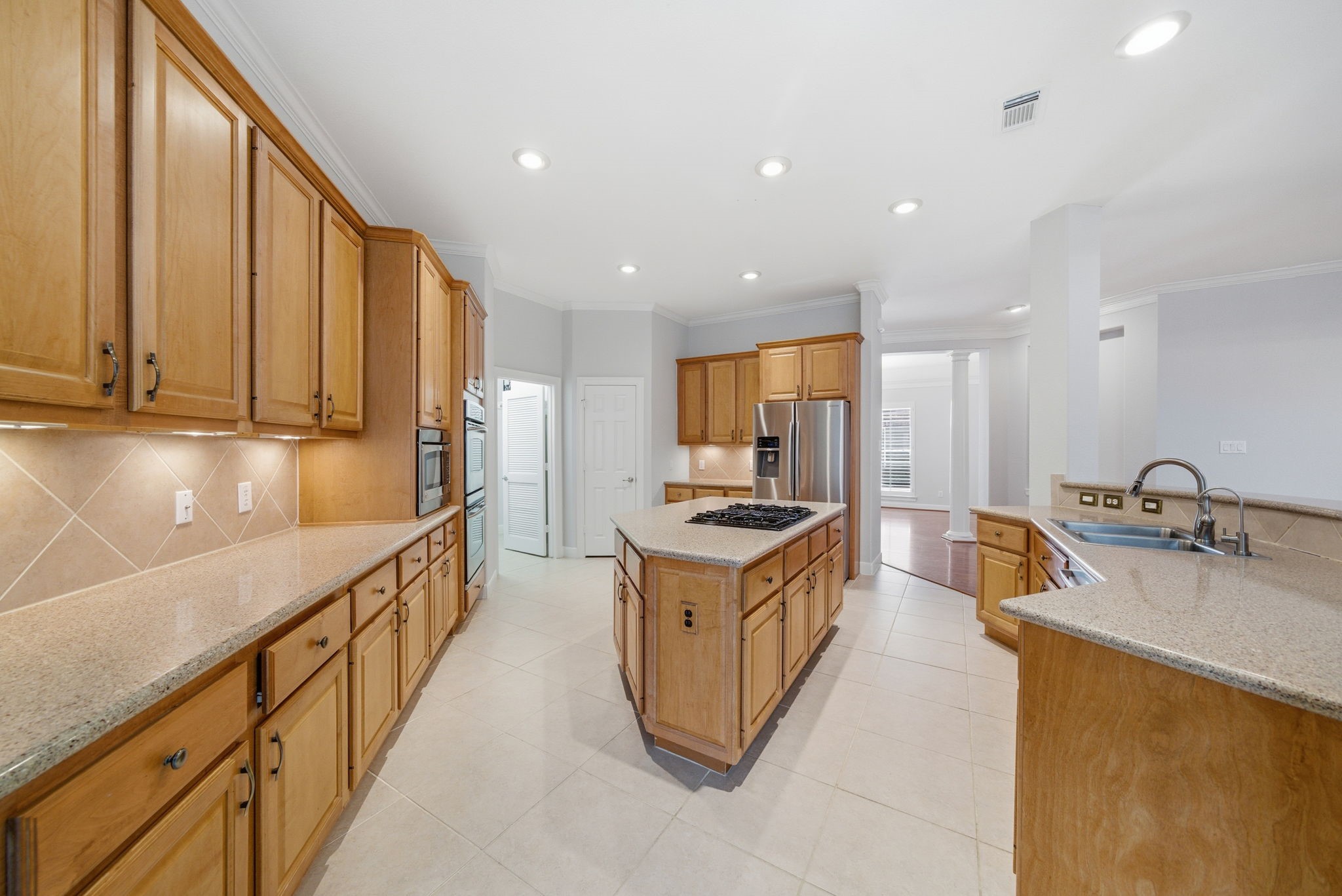 2842 Nicks Run Lane Katy, TX 77494 - Photo 12 of 35 a kitchen with stainless steel appliances granite countertop a sink stove and refrigerator