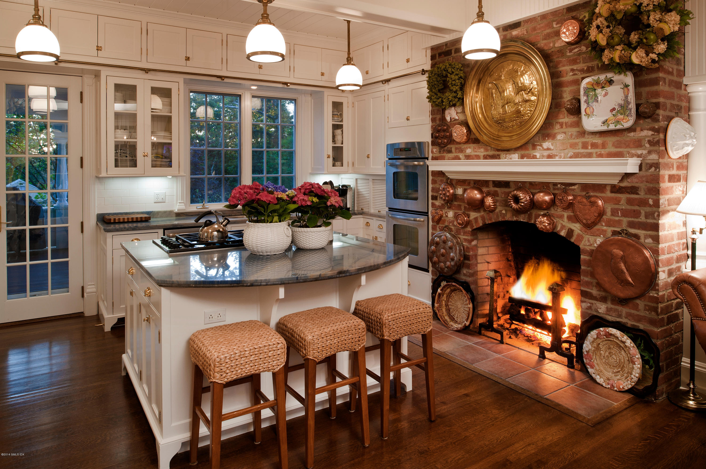 11 Club Road Riverside, CT 06878 - Photo 7 of 16 a kitchen with a table chairs a clock and a rug