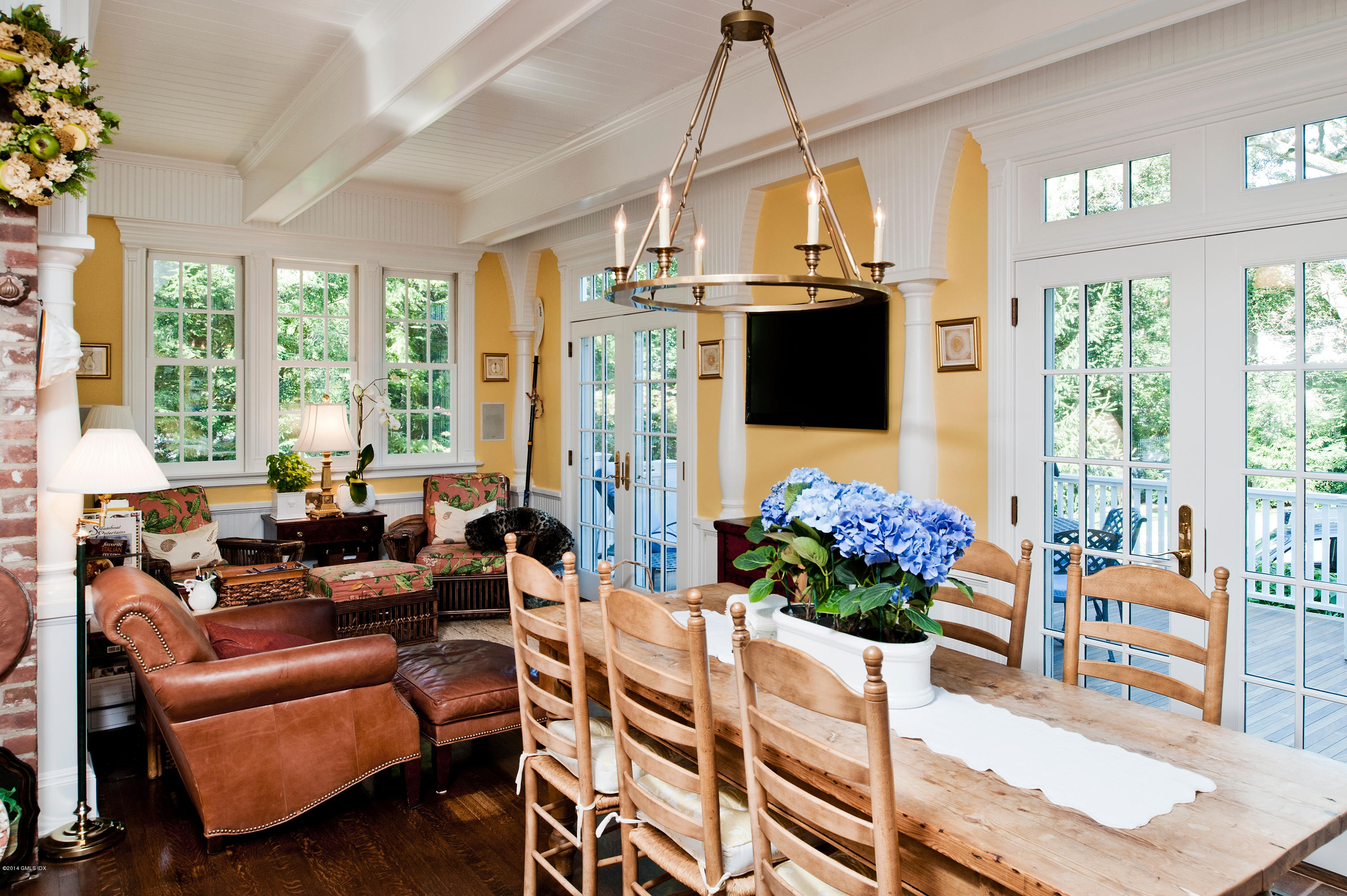 11 Club Road Riverside, CT 06878 - Photo 10 of 16 a living room with patio furniture and a chandelier