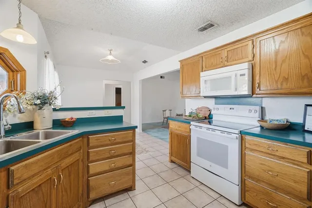 a kitchen with granite countertop a sink and cabinets