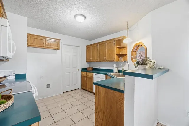 a kitchen with a sink and a refrigerator