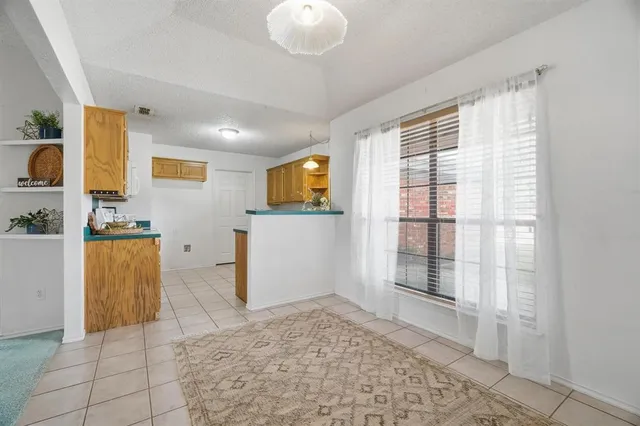 a view of kitchen with furniture and refrigerator