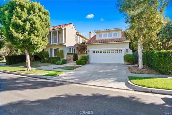 a view of a house with a yard and a fountain