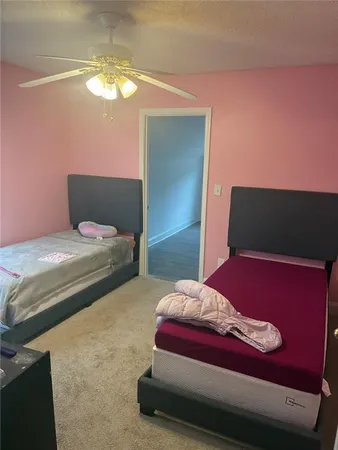 a bedroom with a bed and a potted plant