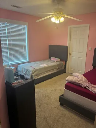a bedroom with bed and window
