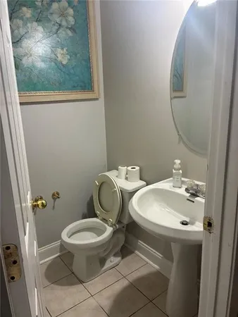 a white toilet sitting next to a bathroom sink