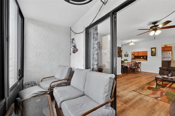 a living room with furniture and a floor to ceiling window