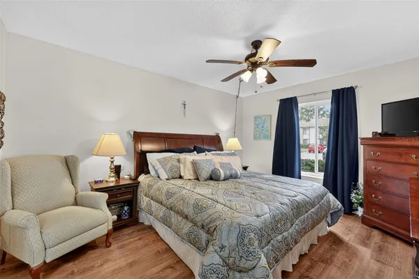 a bedroom with a bed window and dresser