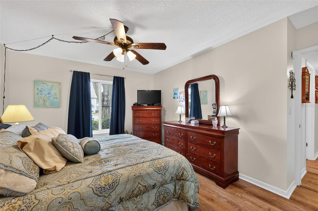 1258 Pine Ridge Circle West, Unit D1 Tarpon Springs, FL 34688 - Photo 20 of 42 a bedroom with a bed window and dresser