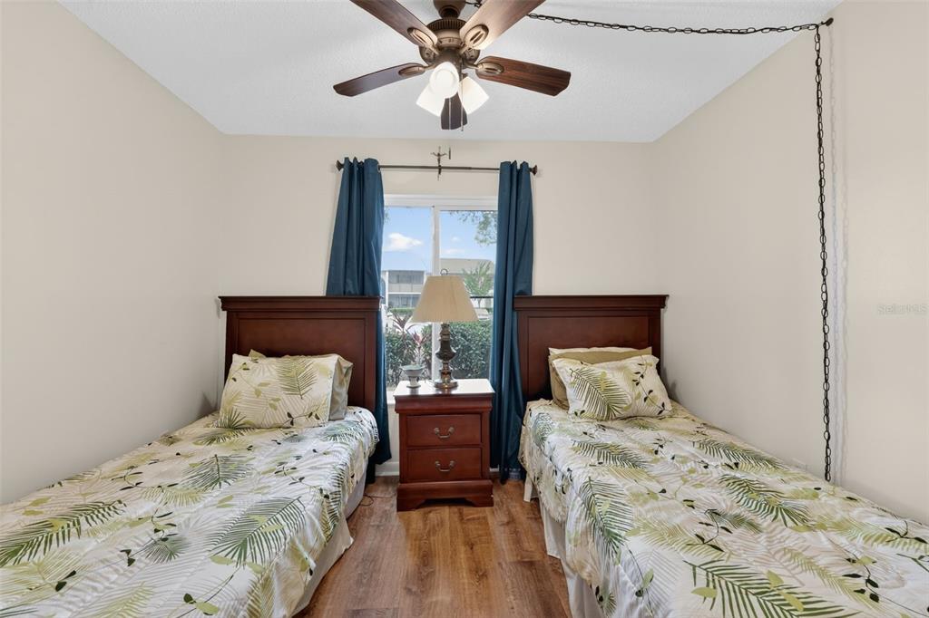 1258 Pine Ridge Circle West, Unit D1 Tarpon Springs, FL 34688 - Photo 23 of 42 a bedroom with a bed and a window
