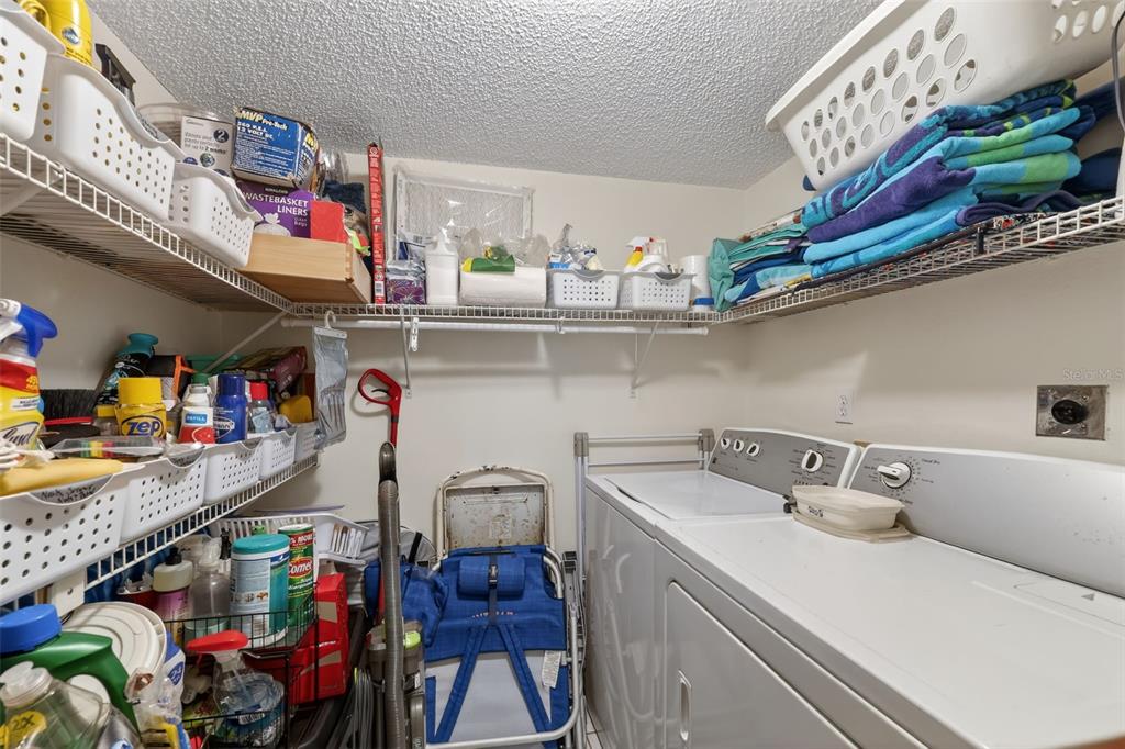 1258 Pine Ridge Circle West, Unit D1 Tarpon Springs, FL 34688 - Photo 26 of 42 a utility room with stainless steel appliances a sink and cabinets
