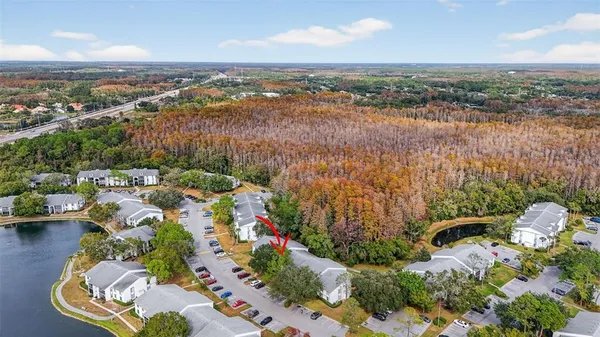 an aerial view of lake and residential houses with outdoor space