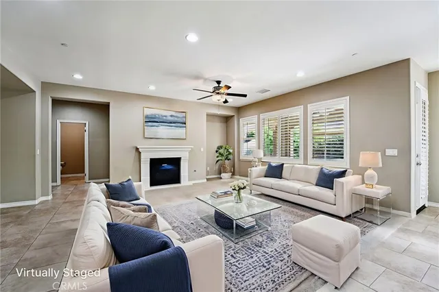 a living room with furniture large window and a fireplace