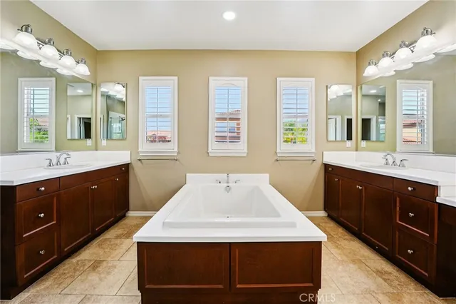 a spacious bathroom with a sink double vanity and a mirror