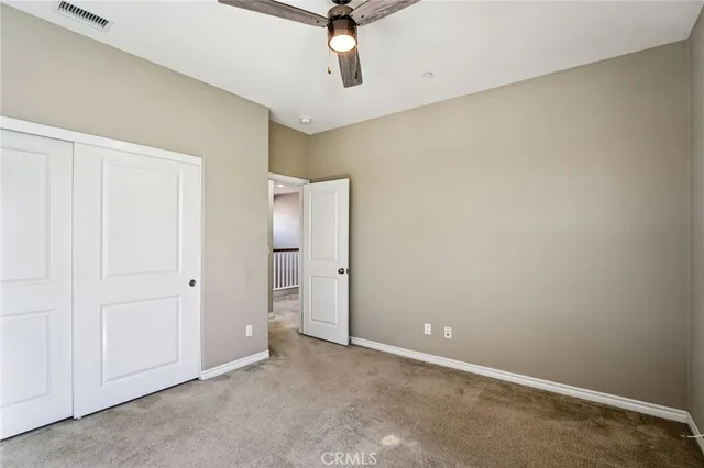 an empty room with a ceiling fan