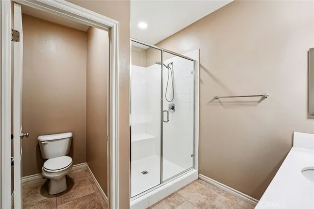 a bathroom view of a toilet and a shower