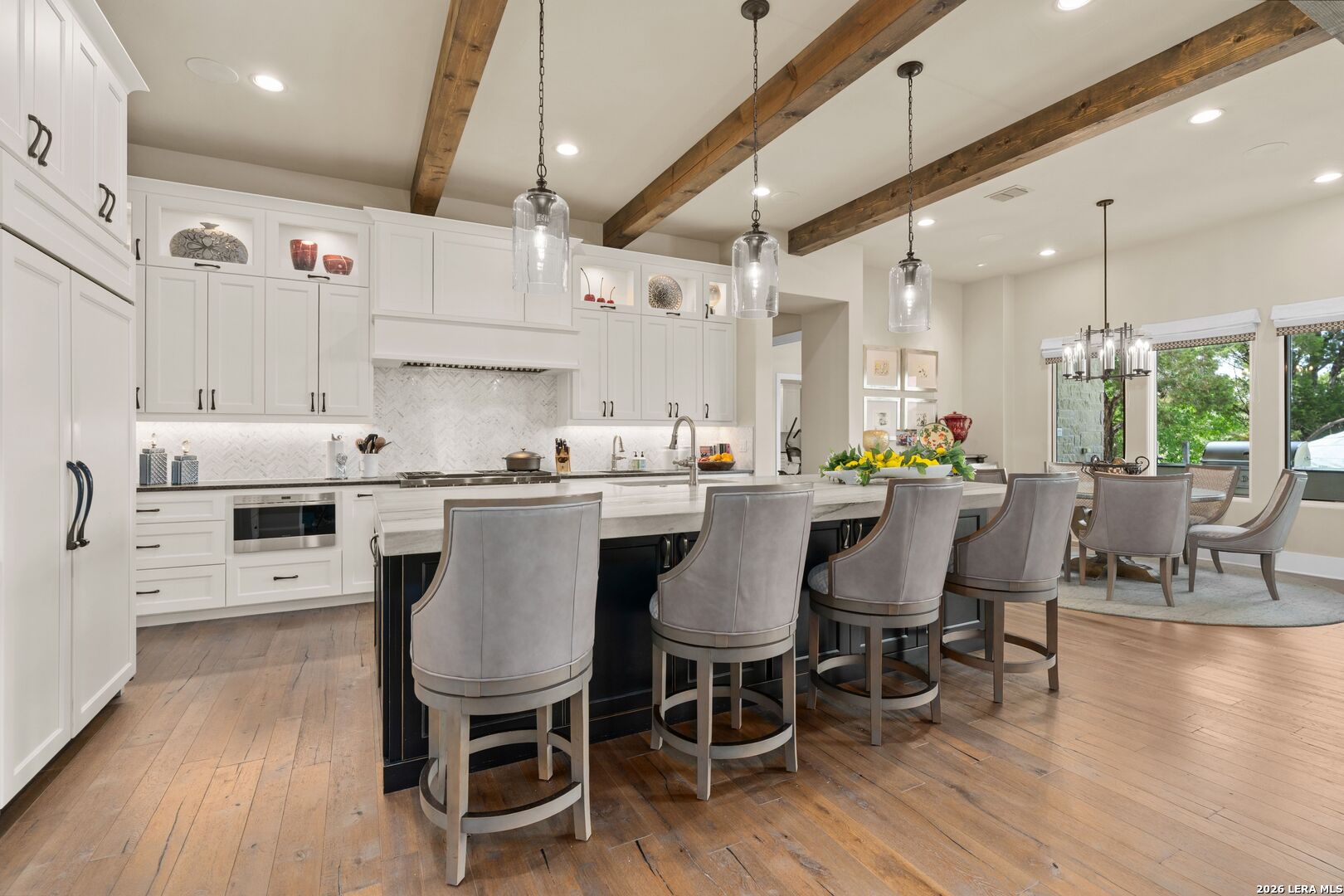 52 Landmark Ridge Bergheim, TX 78004 - Photo 9 of 24 a kitchen with stainless steel appliances a table chairs refrigerator and cabinets