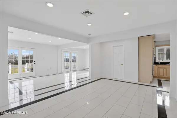 a kitchen with stainless steel appliances granite countertop a sink a stove and a refrigerator