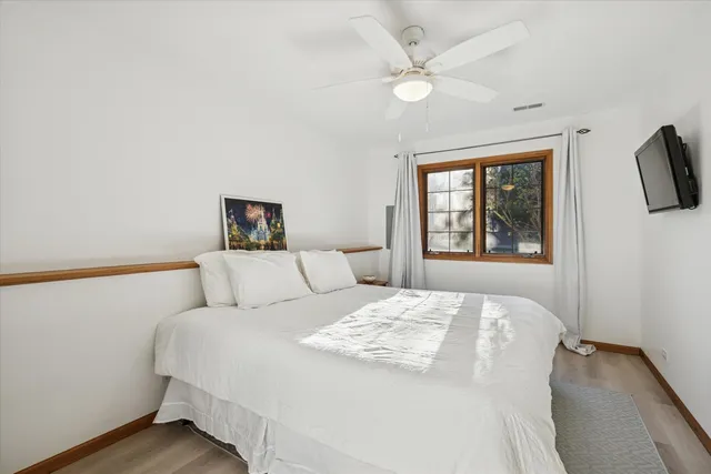 a bedroom with a large bed and a window