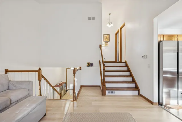 a view of a hallway with staircase and white walls