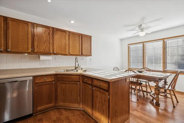 a kitchen with a sink a stove cabinets and dining table