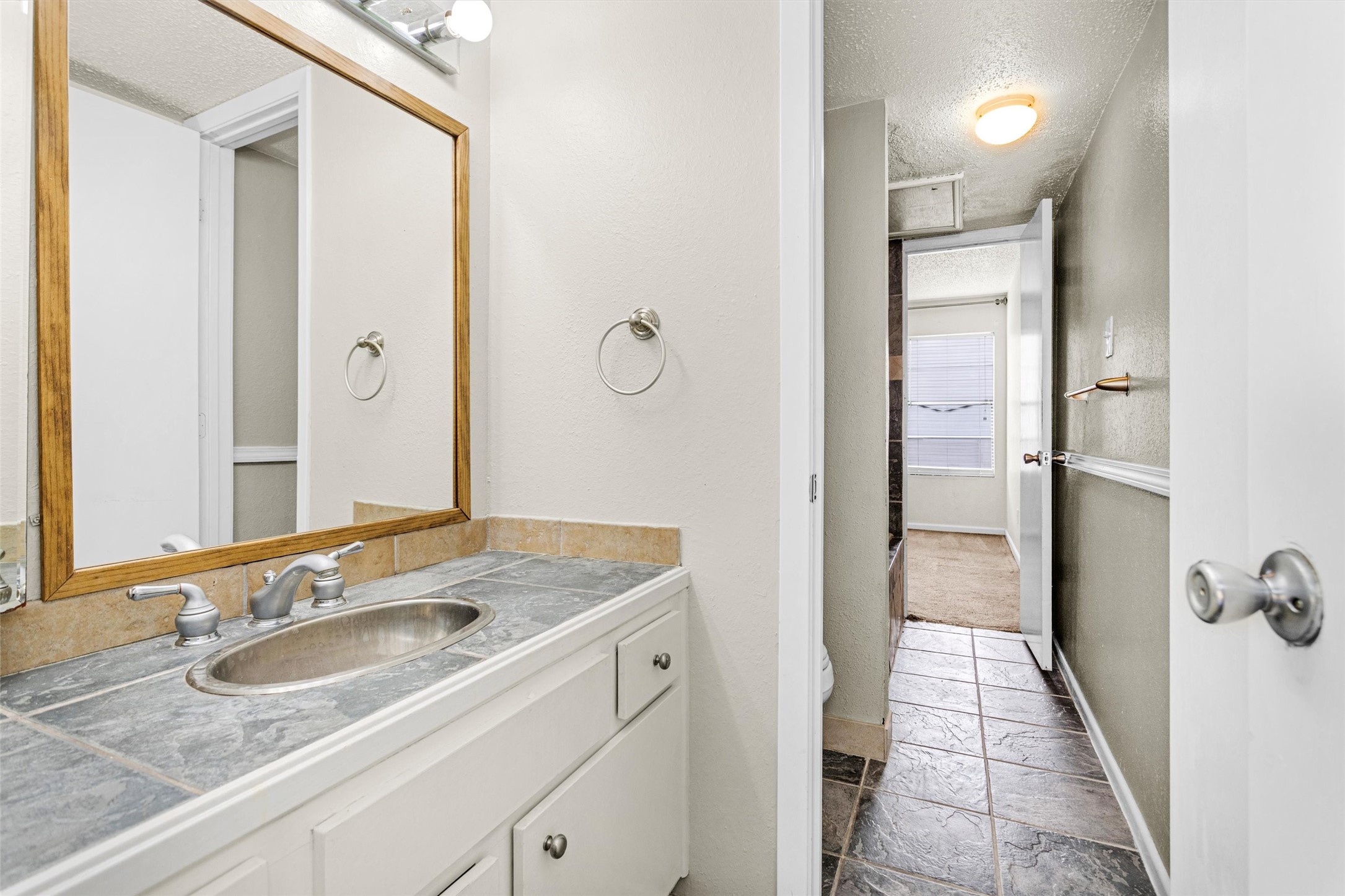 12900 Walden Road, Unit 513 Montgomery, TX 77356 - Photo 16 of 20 a bathroom with a sink and a mirror