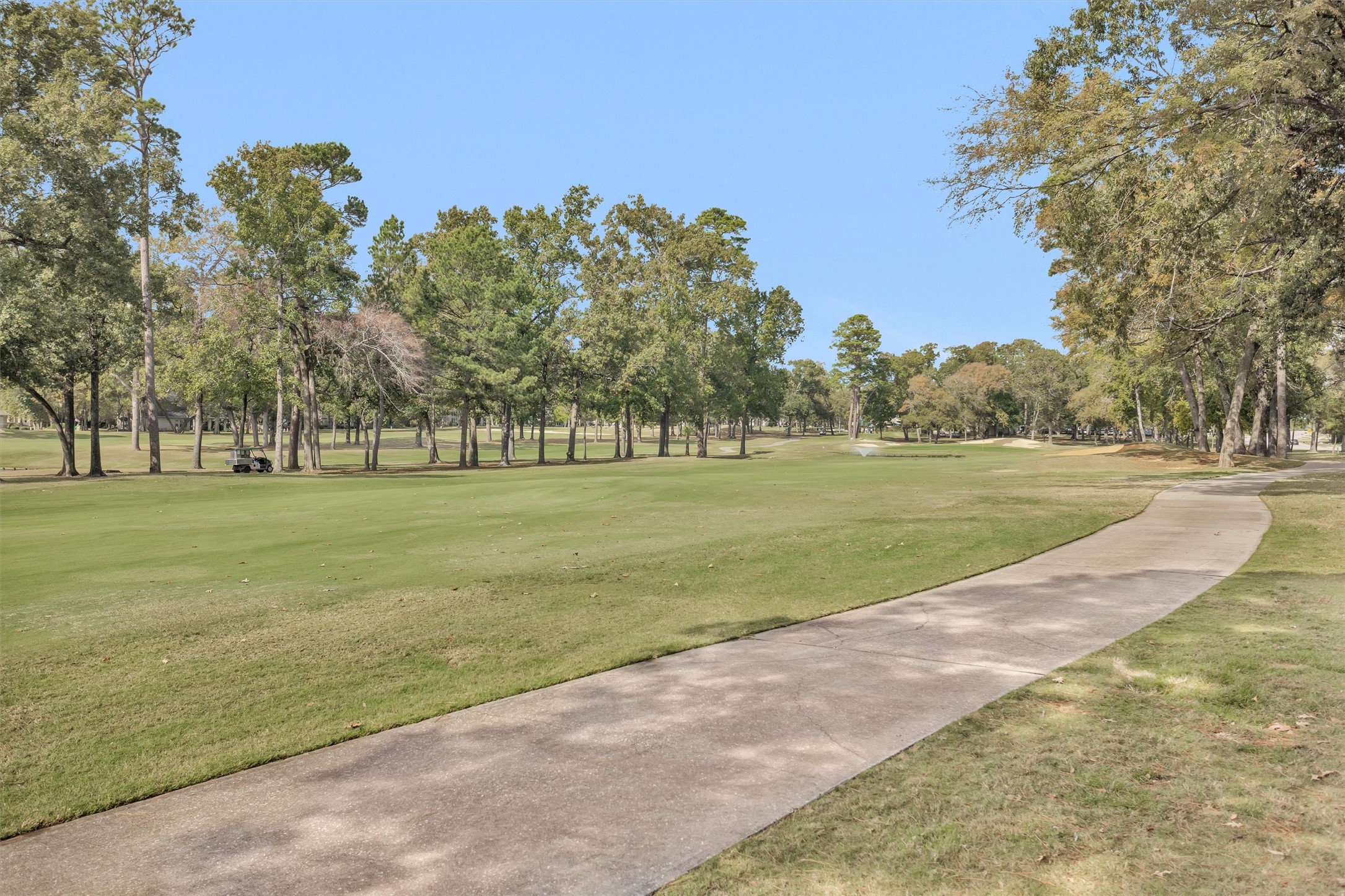 12900 Walden Road, Unit 513 Montgomery, TX 77356 - Photo 18 of 20 a view of a golf course with a garden