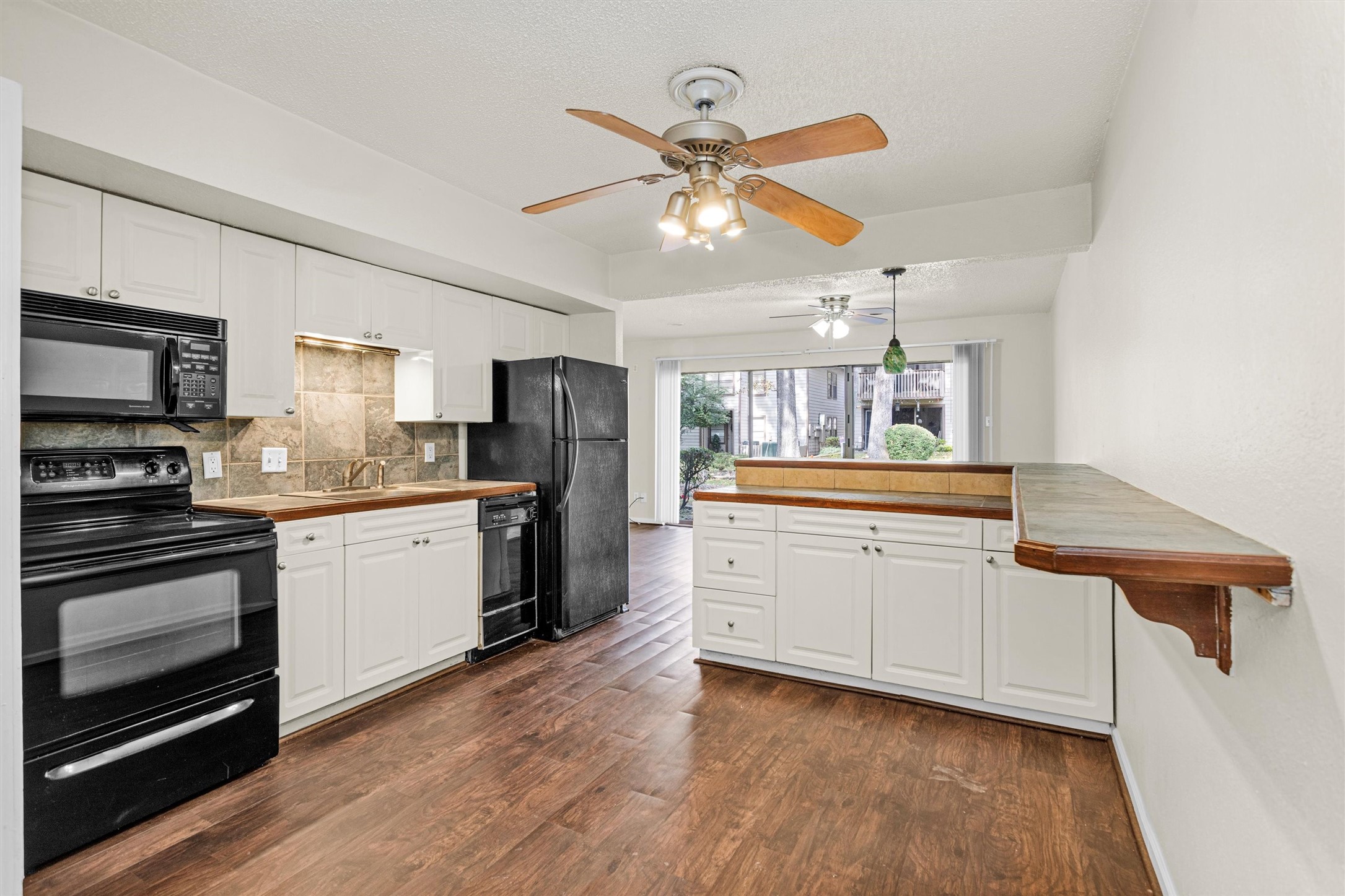 12900 Walden Road, Unit 513 Montgomery, TX 77356 - Photo 2 of 20 a kitchen with stainless steel appliances granite countertop a stove cabinets and wooden floor