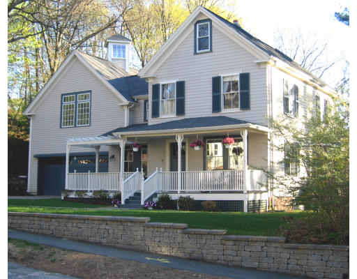 a front view of a house with a yard and plants