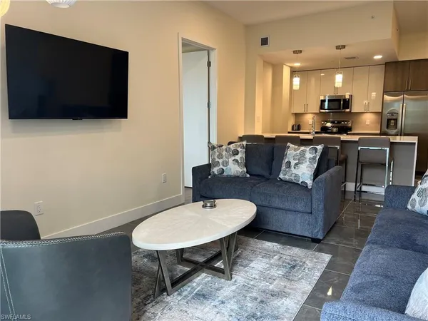 a living room with furniture and a flat screen tv