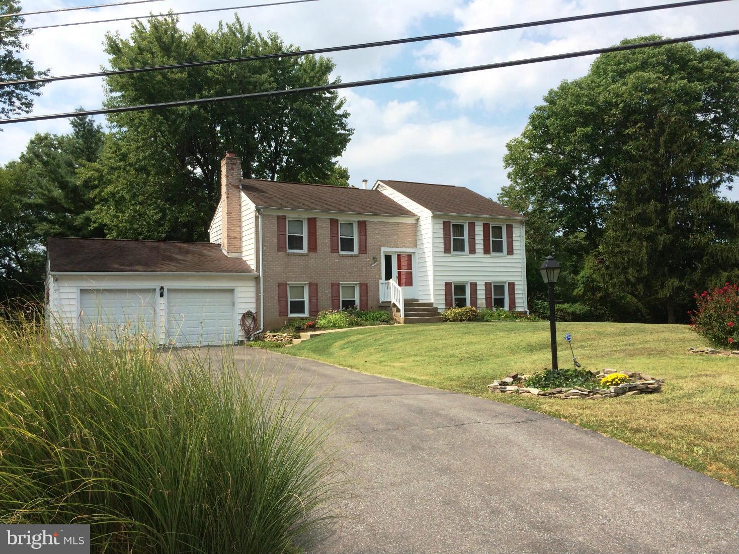 17030 Hughes Road Poolesville, MD 20837 - Photo 1 of 24 a house view with a garden space