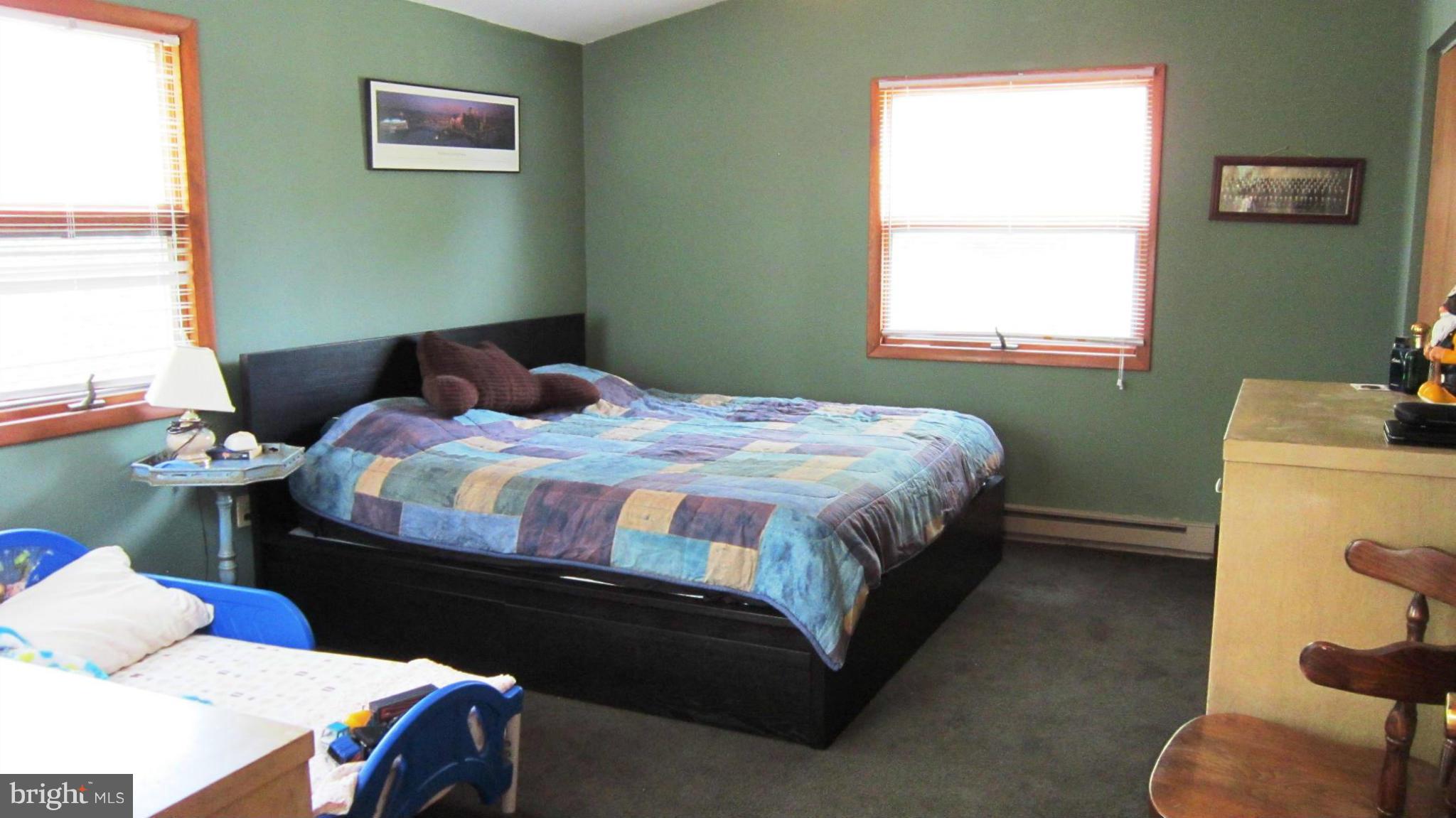 17030 Hughes Road Poolesville, MD 20837 - Photo 14 of 24 a bedroom with a bed and a window