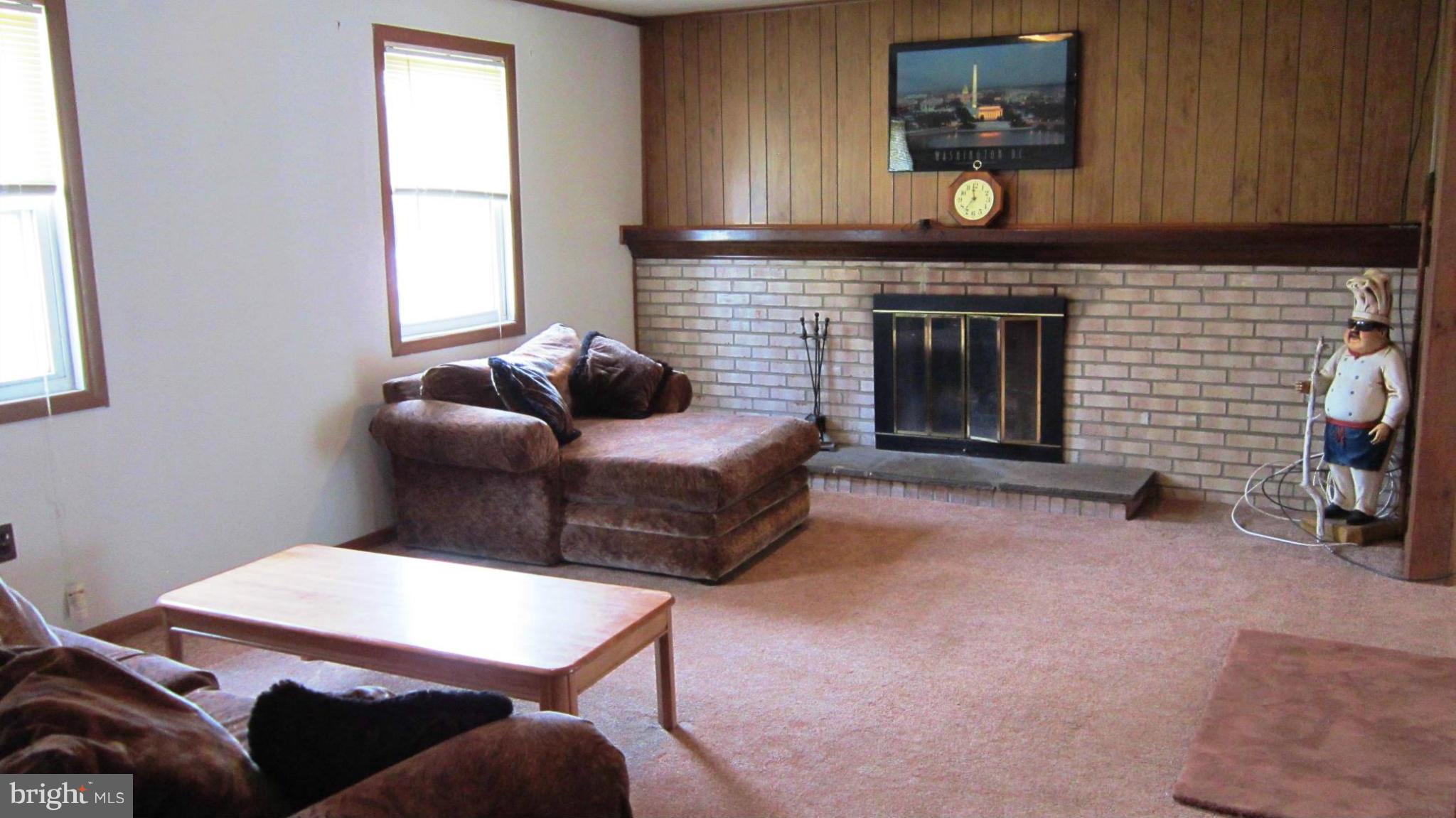 17030 Hughes Road Poolesville, MD 20837 - Photo 19 of 24 a living room with furniture and a fireplace