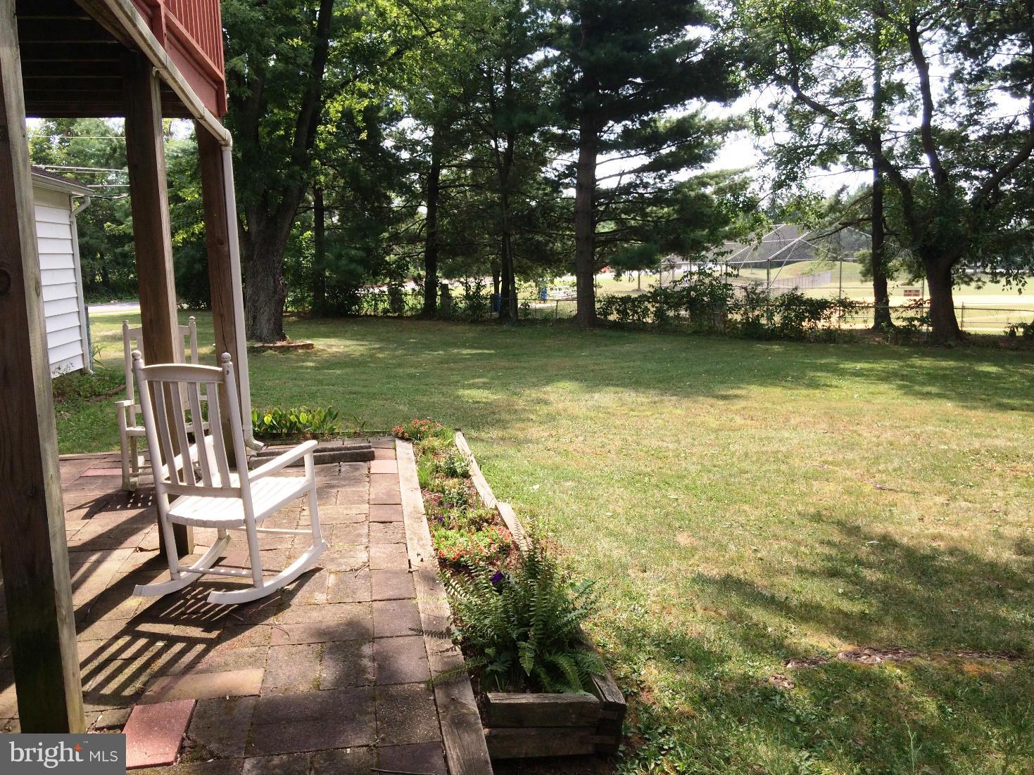 17030 Hughes Road Poolesville, MD 20837 - Photo 22 of 24 a view of a patio with table and chairs potted plants and large tree