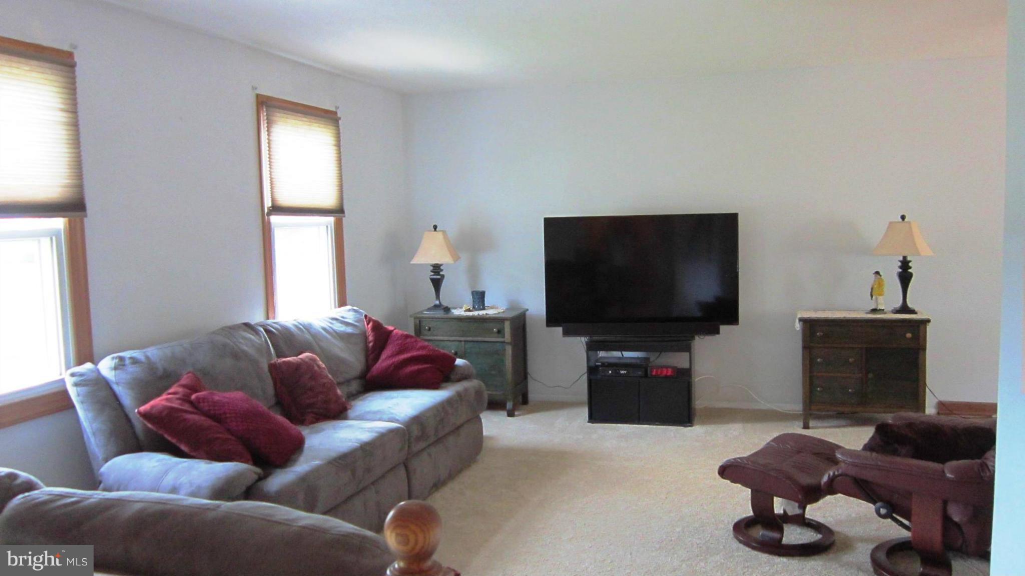 17030 Hughes Road Poolesville, MD 20837 - Photo 8 of 24 a living room with furniture and a flat screen tv