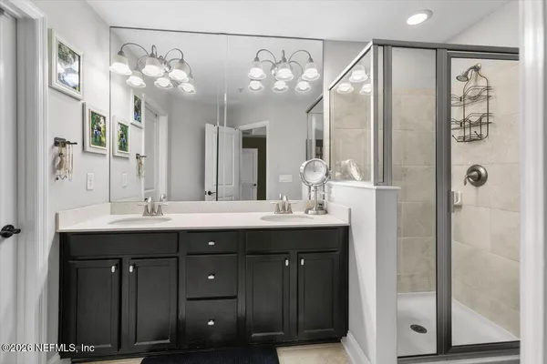 a bathroom with a double vanity sink and a mirror