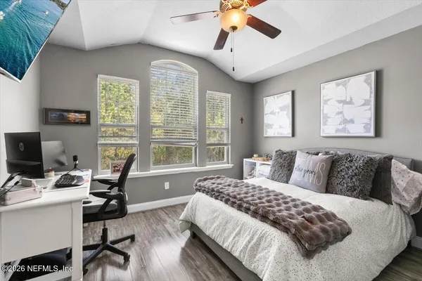 a bedroom with a bed and a desk