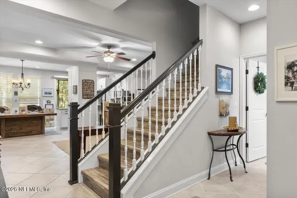 a view of a hallway with wooden floor and staircase