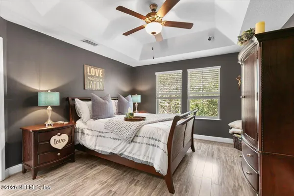 a bedroom with a bed and a chandelier