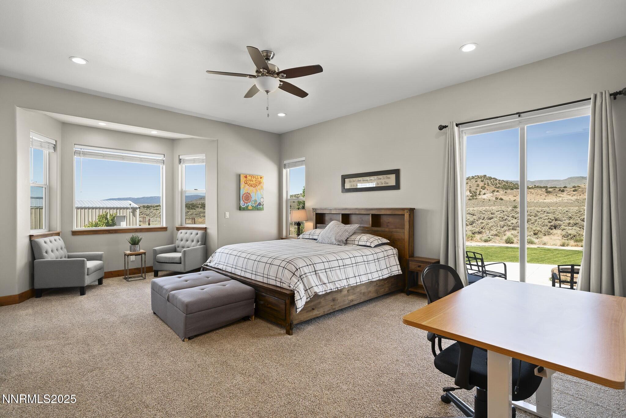 1240 Antelope Valley Road Reno, NV 89508 - Photo 21 of 60 a bedroom with a bed a couch and a large window