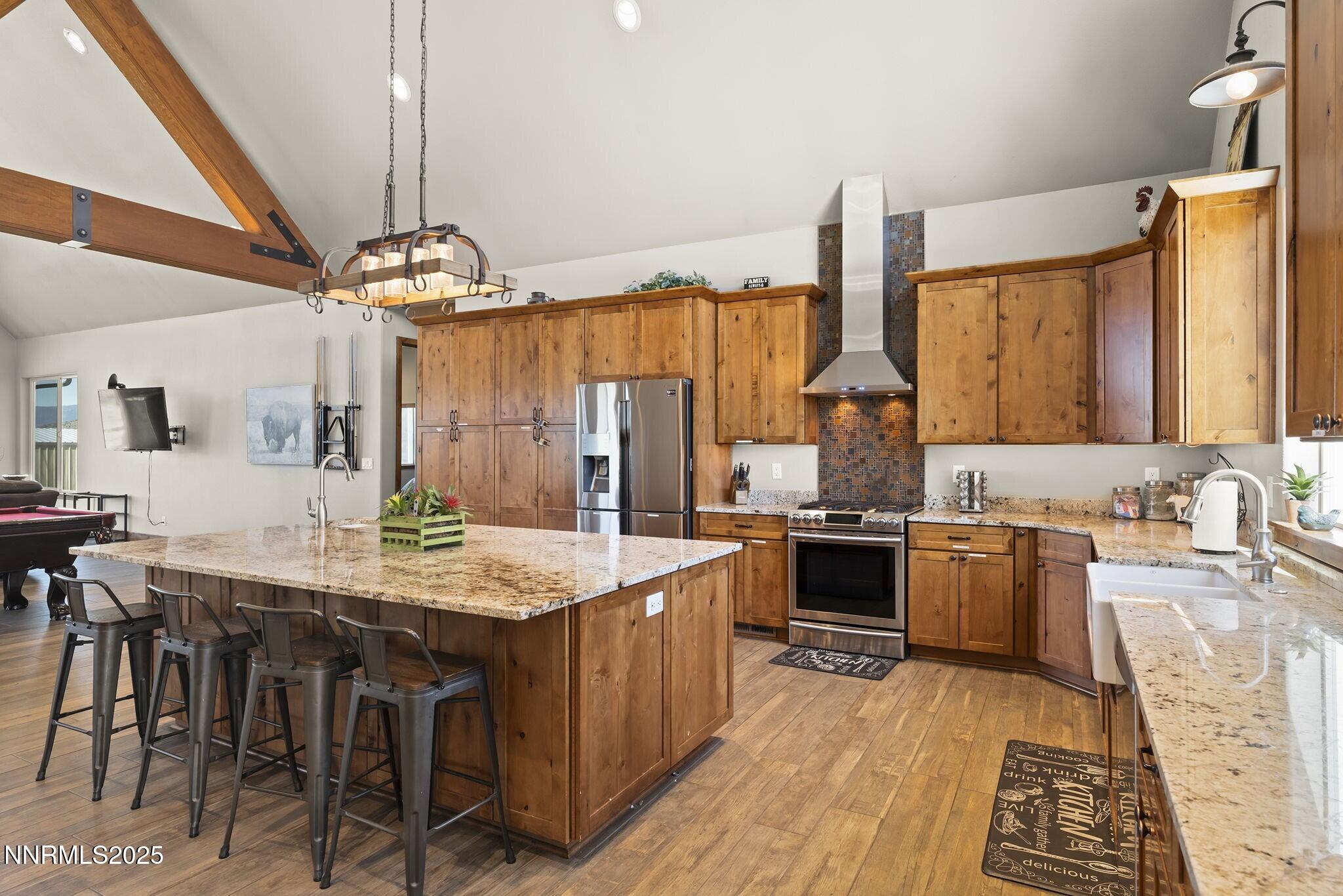 1240 Antelope Valley Road Reno, NV 89508 - Photo 4 of 60 a kitchen with a stove a sink a dining table and chairs