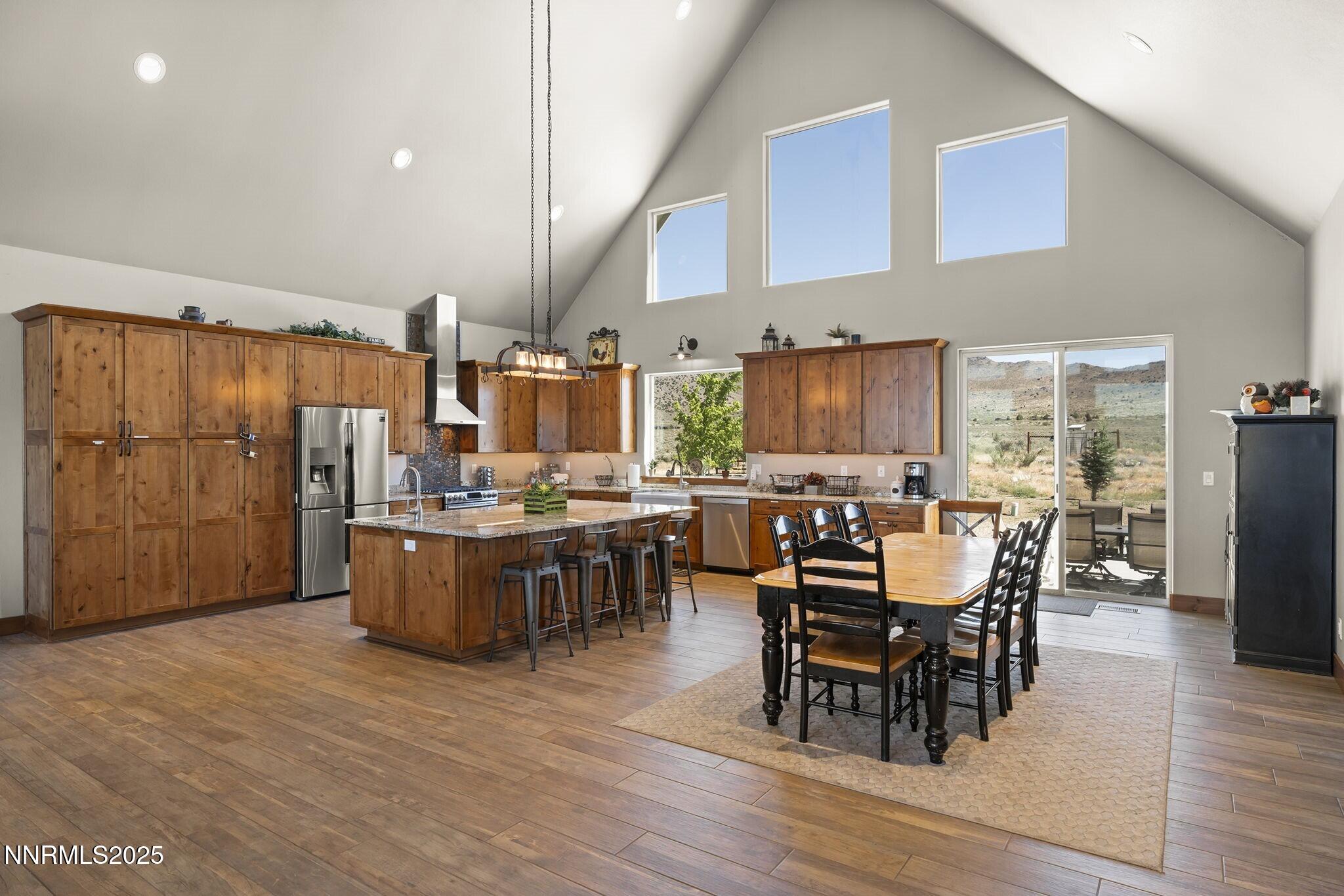 1240 Antelope Valley Road Reno, NV 89508 - Photo 9 of 60 a dining hall with stainless steel appliances kitchen island granite countertop furniture and wooden floor