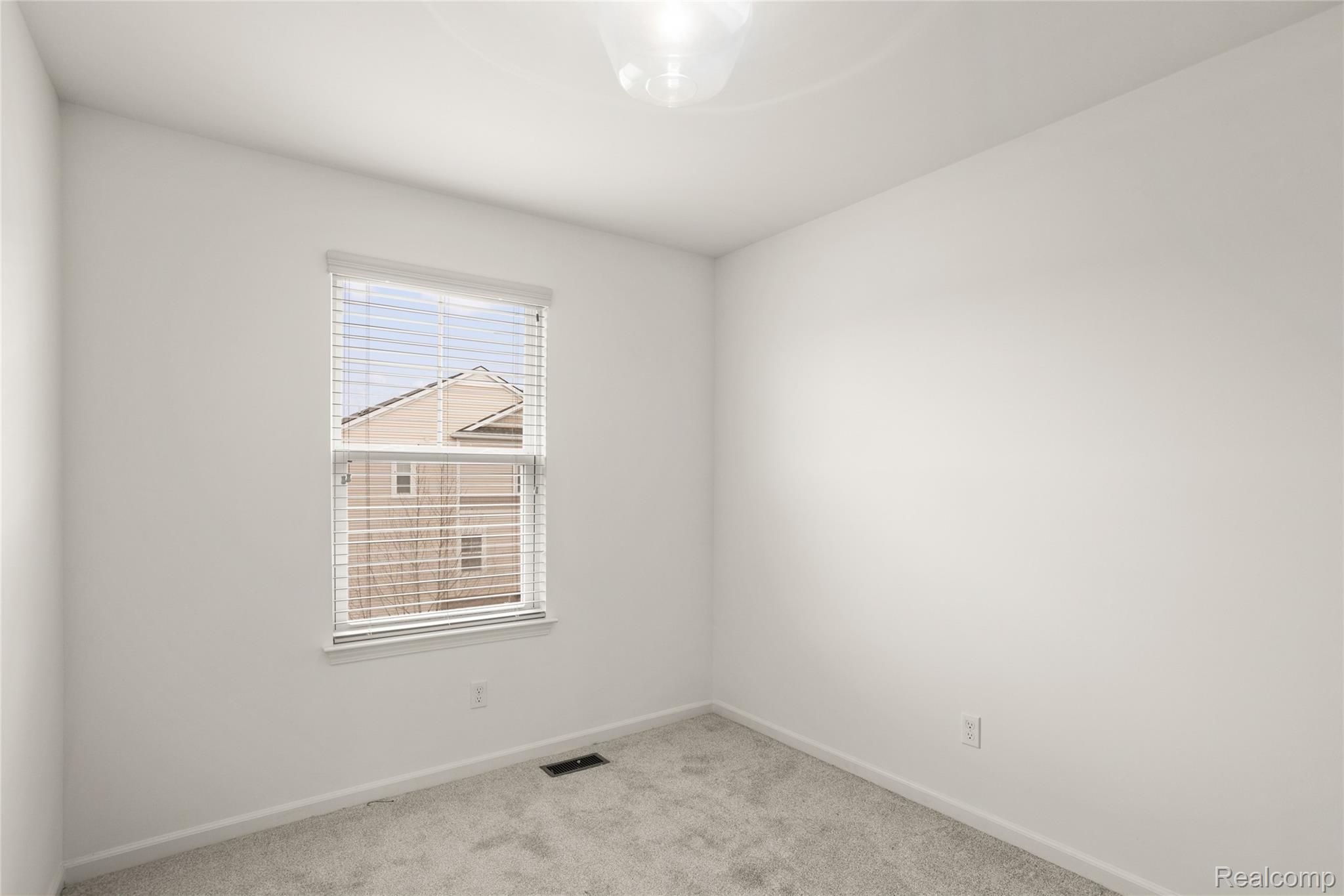 478 North Wixom Road Wixom, MI 48393 - Photo 21 of 26 Spare room featuring light carpet and baseboards
