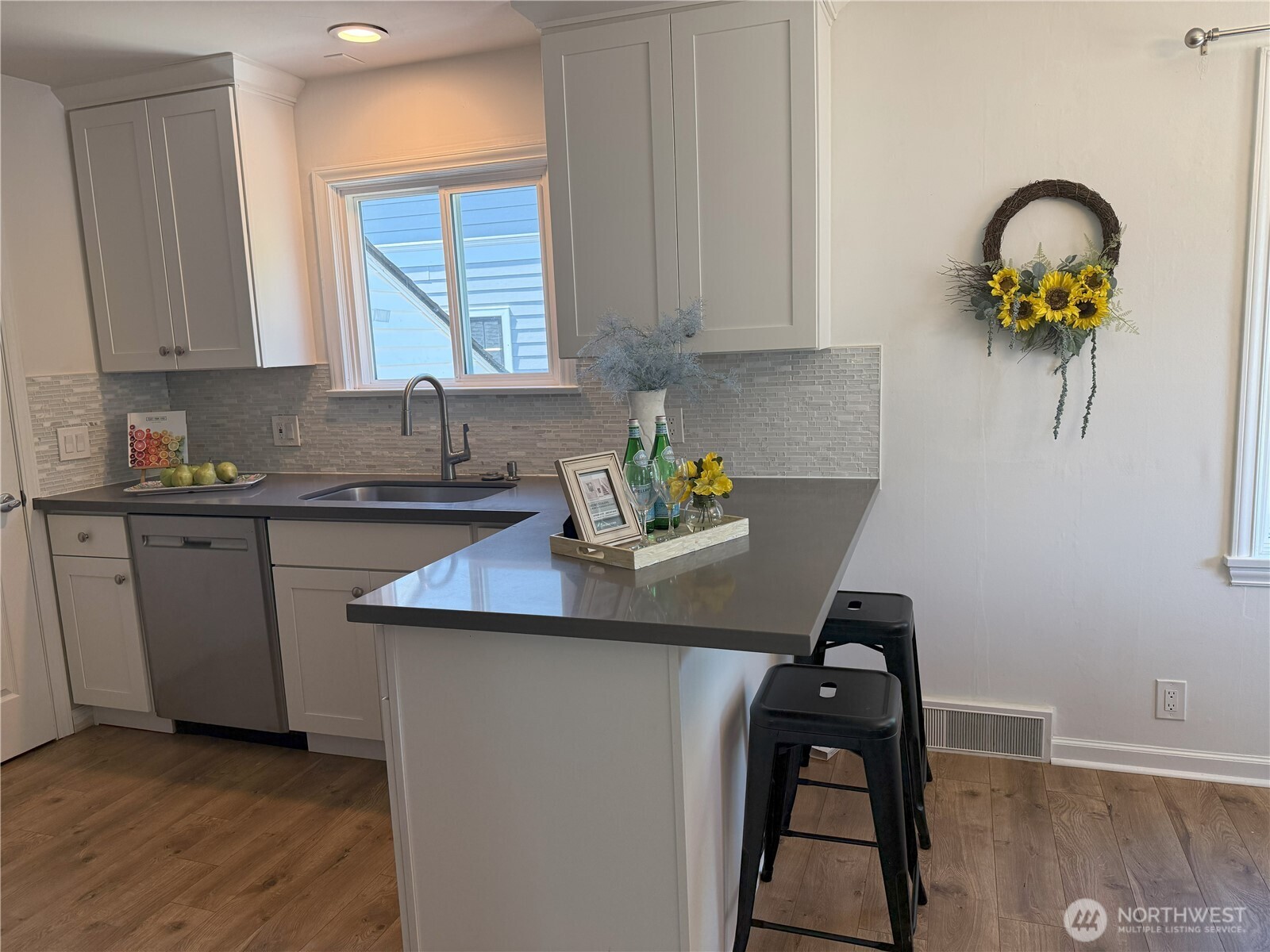 4329 Northeast 56th Street Seattle, WA 98105 - Photo 12 of 34 a kitchen with a sink a stove and cabinets