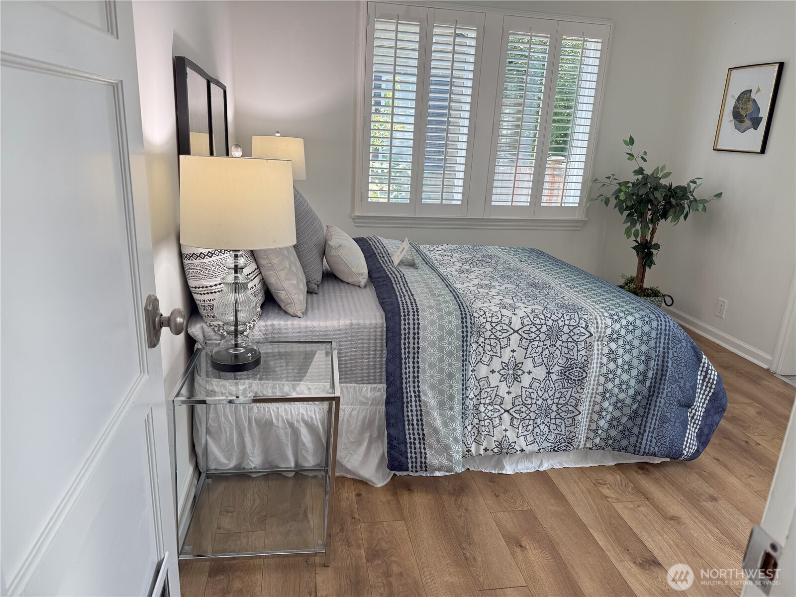 4329 Northeast 56th Street Seattle, WA 98105 - Photo 14 of 34 a bed sitting in a bedroom next to a window